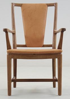 A Carl-Axel Acking walnut armchair, upholstered in light brown leather, Nordiska Kompaniet, Sweden, ca 1947.
