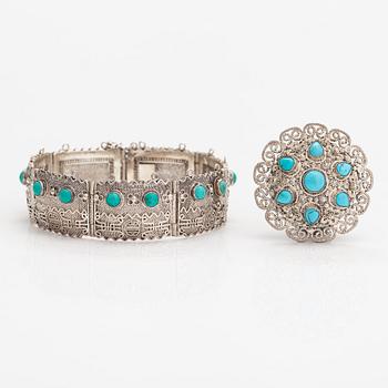 A silver bracelet and ring with turquoises. China.