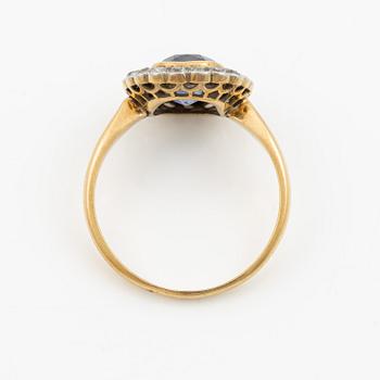 A ring in gold with a cushion-cut purple sapphire and old-cut diamonds, ca first half of the 20th century.