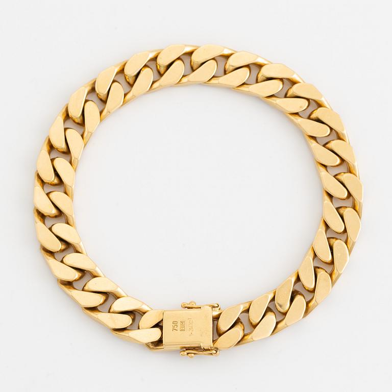 18K gold and brilliant cut diamond curb link bracelet.