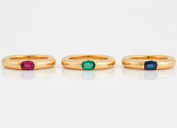 1015. Three Cartier "Ellipse" rings in 18K gold set with a faceted  sapphire, an emerald and a ruby.