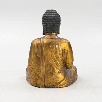 A massive gilded wooden figure of buddha, 20th century.