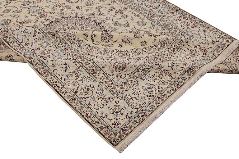 A Nain carpet, part silk, signed, 6 laa, c. 295 x 205 cm.