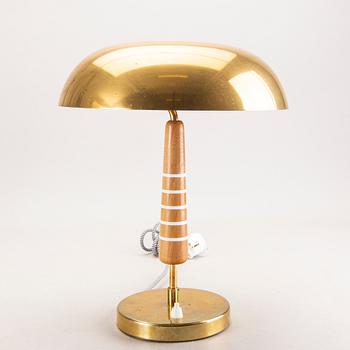 A Swedish Modern 1940s brass and wood lamp.