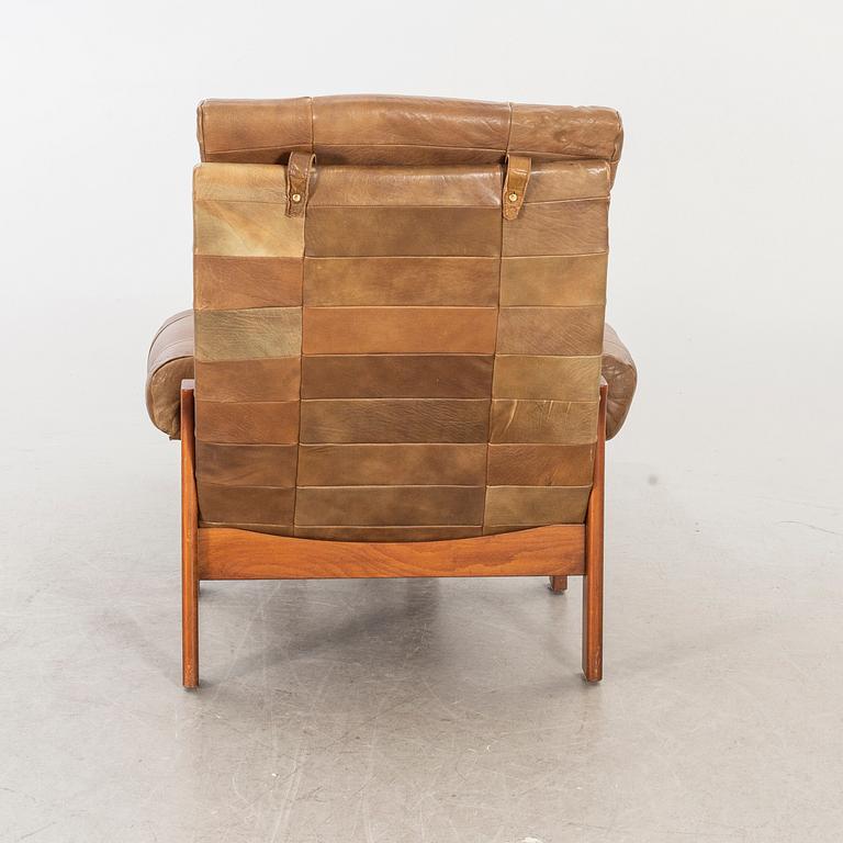 A pair of 1970/80:s easy chairs with stools.