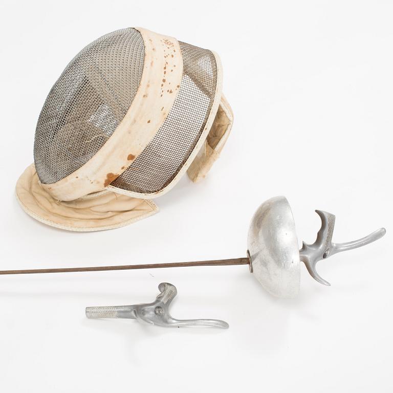 a late 20th century electric epee and a epee fencing mask.