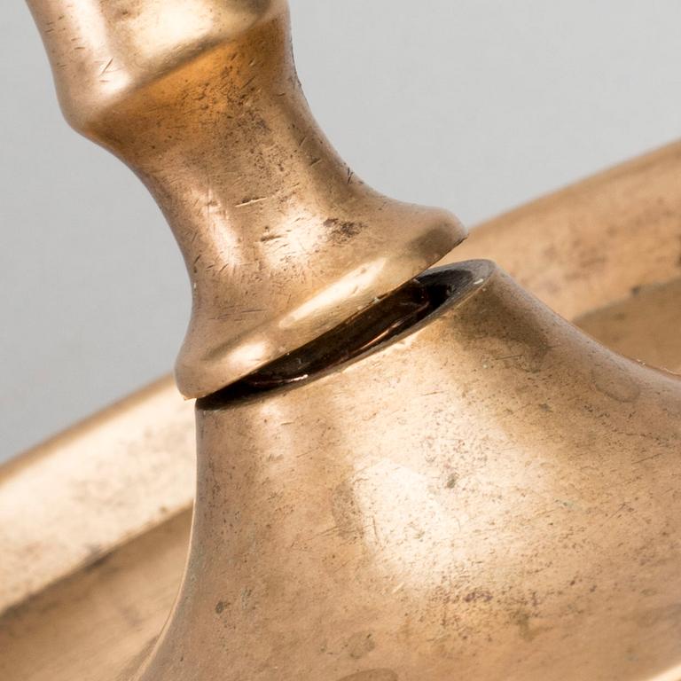 A BRASS CANDLE STICK.