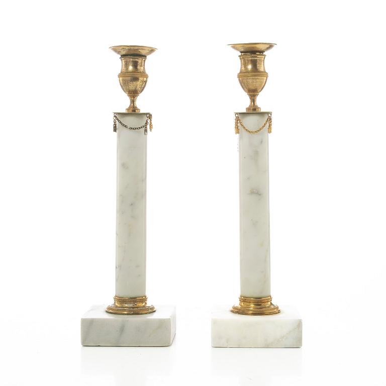 A pair of late Gustavian gilt brass and marble candlesticks, circa 1800.