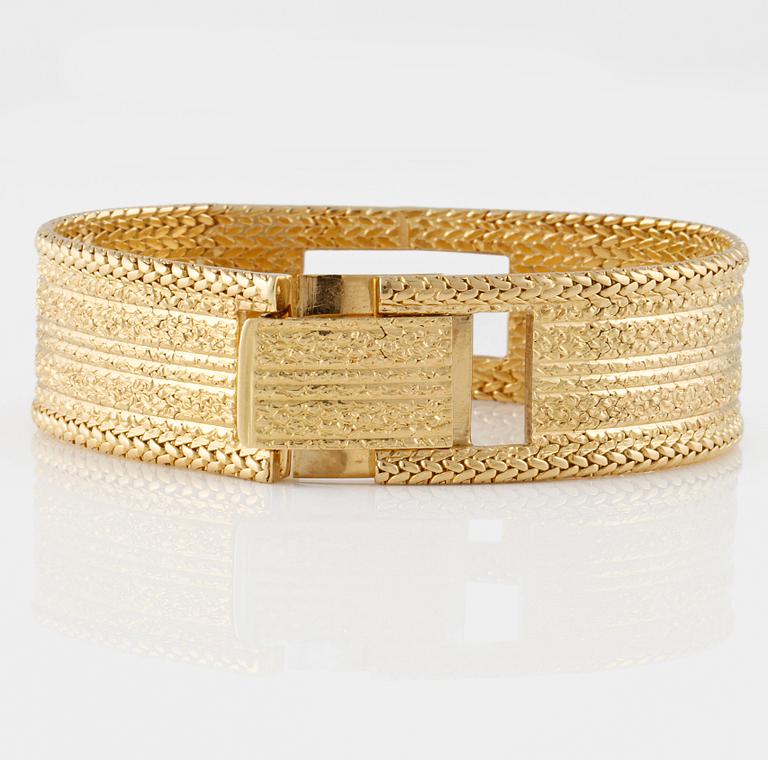 ARMLÄNK, 18K guld med fasettslipad vit syntetisk spinell, importstämplad. Vikt 68,9 gram.