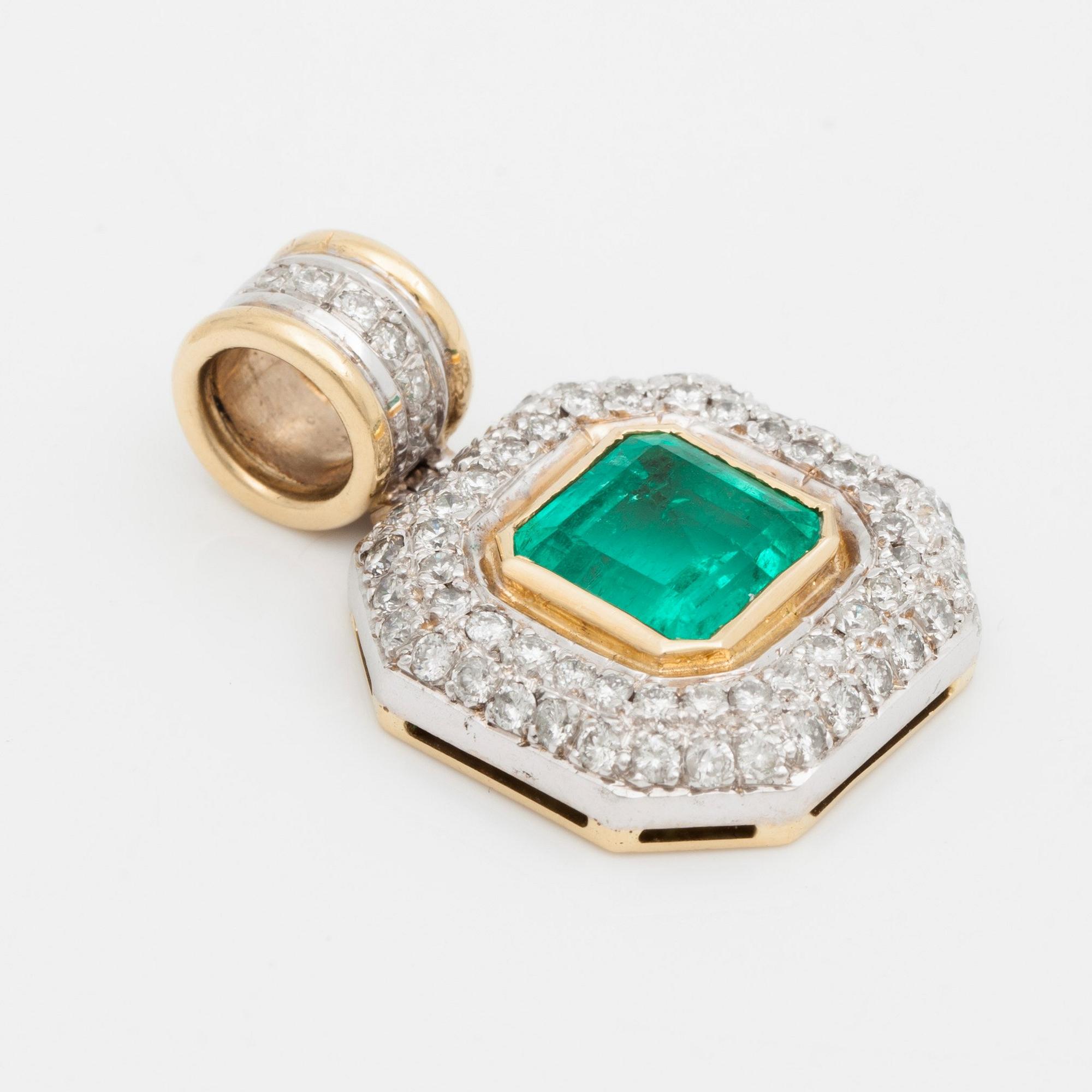 A pendant with a 5.50 ct emerald and cica 1.80 cts of brilliant cut diamonds.