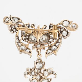 A 14K gold and silver brooch set with old-cut diamonds.