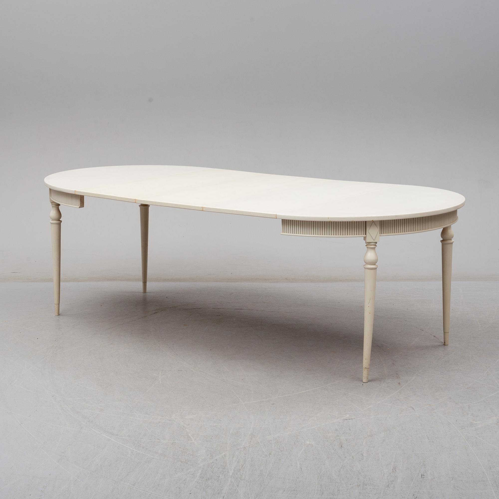 Four chairs with dinner table, late 20th Century.