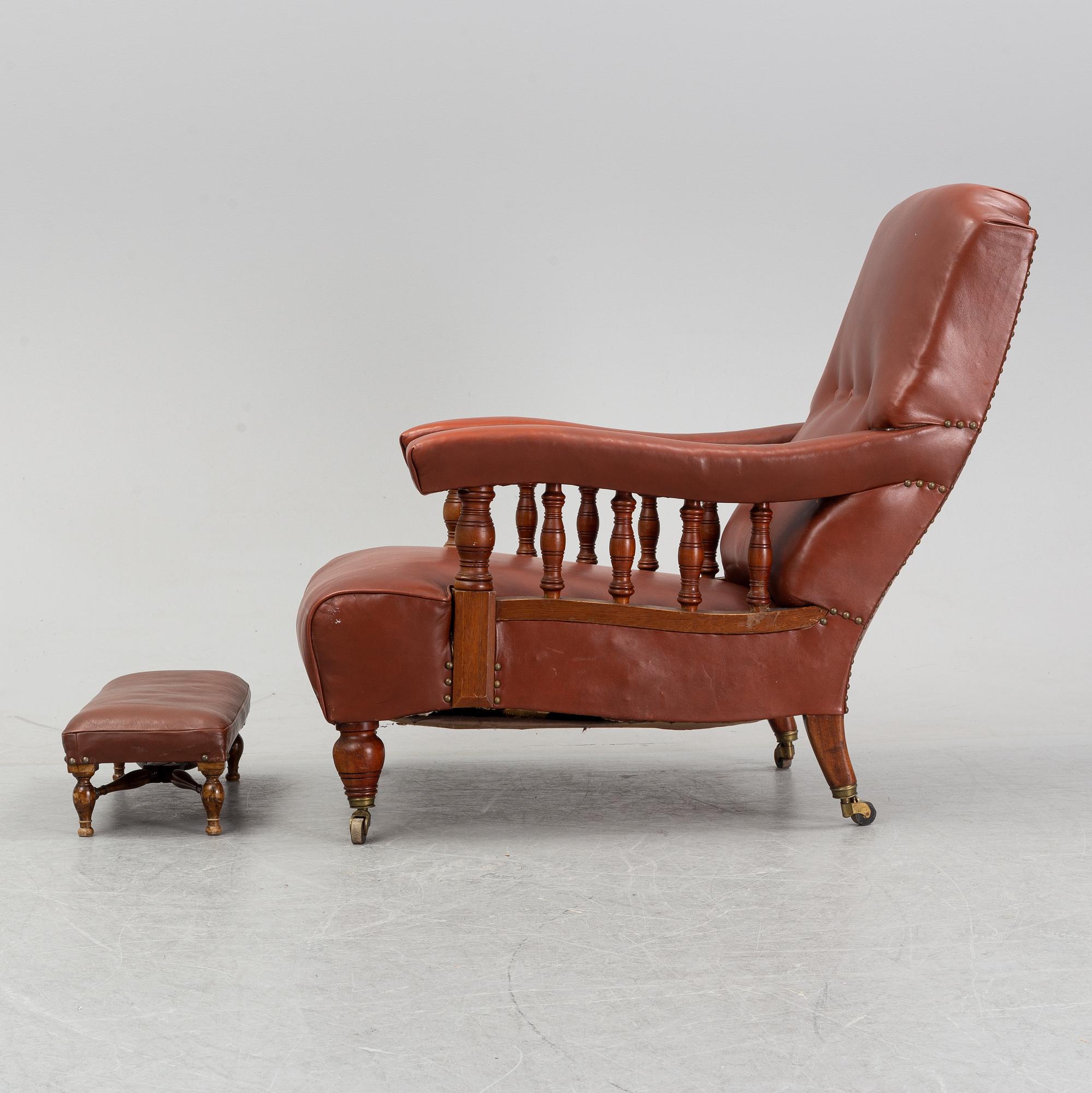 A late empire armchair with stool, mid 19th century.