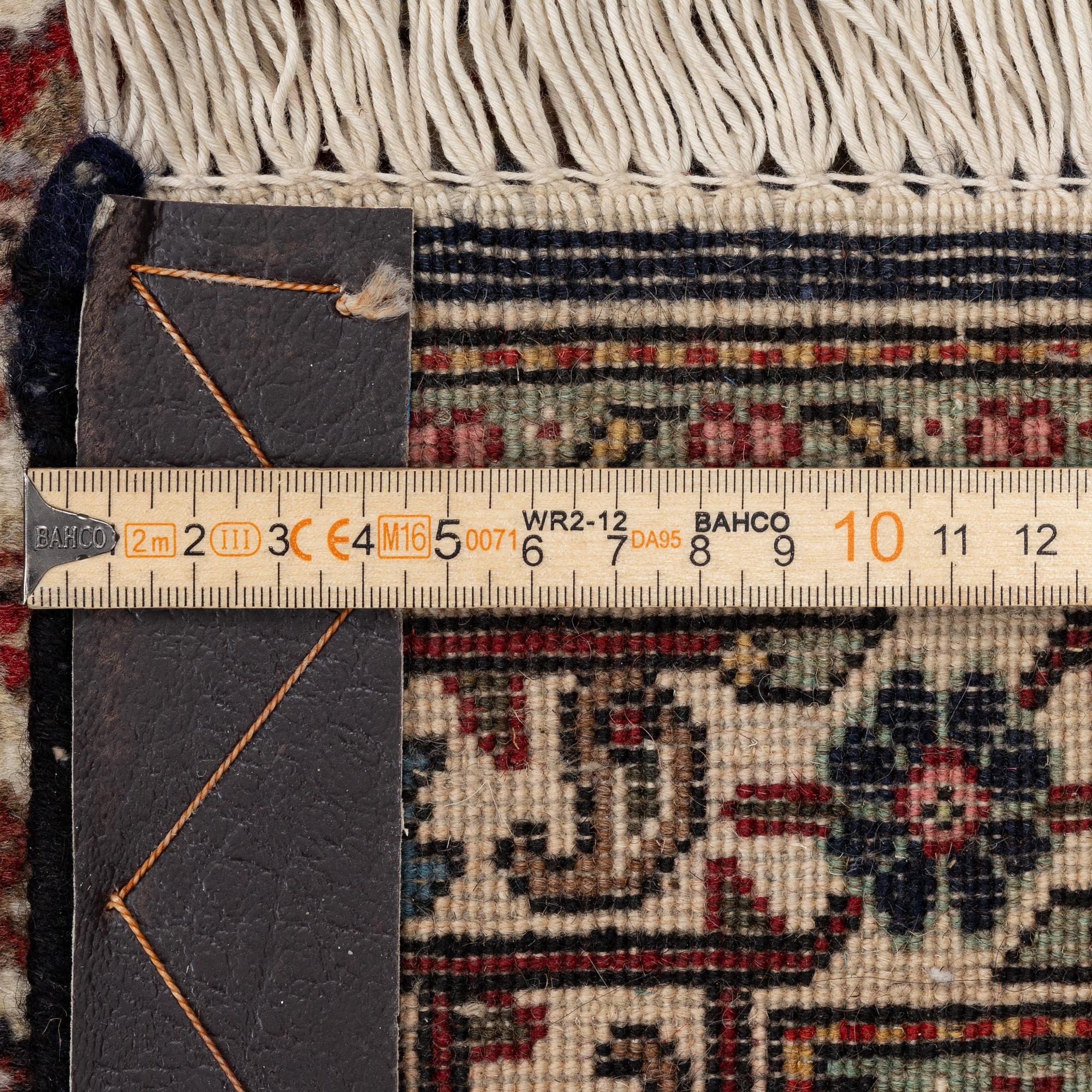 A signed Tabriz carpet, c. 385 x 300 cm.