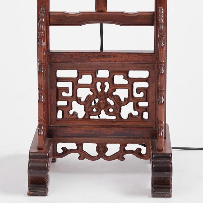 A Chinese wooden floor lamp, later part of the 20th century.
