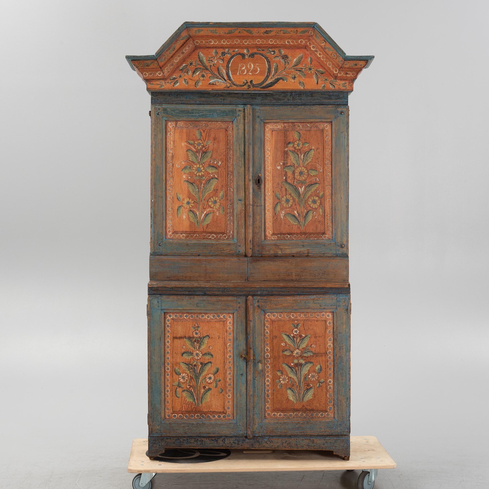 A painted cabinet, dated 1825.