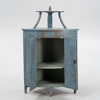 A painted corner cabinet, late 19th century.