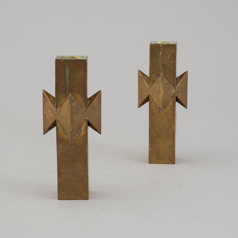 A pair of brass candlesticks by Pierre Forssell for Skultuna.