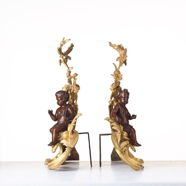 A pair of Louis XV-style 19th century fire dogs.