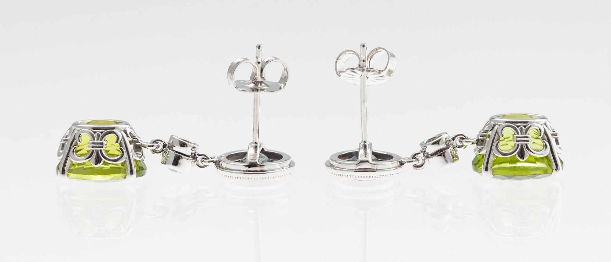 KORVAKORUT, 14K valkokultaa. Peridootit 6.39 ct, lilat safiirit 1.45 ct, Briljanttihiotut timantit 0.10 ct. W/vs.