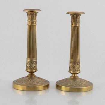 A pair of Empire gilt brass candle sticks, first half of the 20th century.