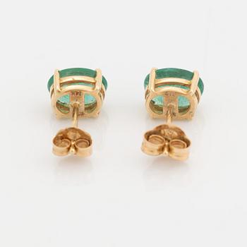 Gold and oval emerald earrings.
