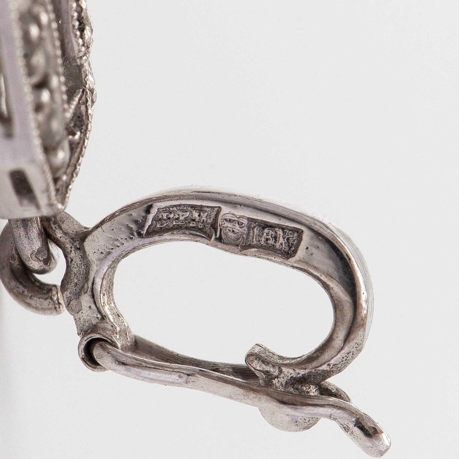 An 18K white gold pendant set with brilliant-cut and rose-cut diamonds.