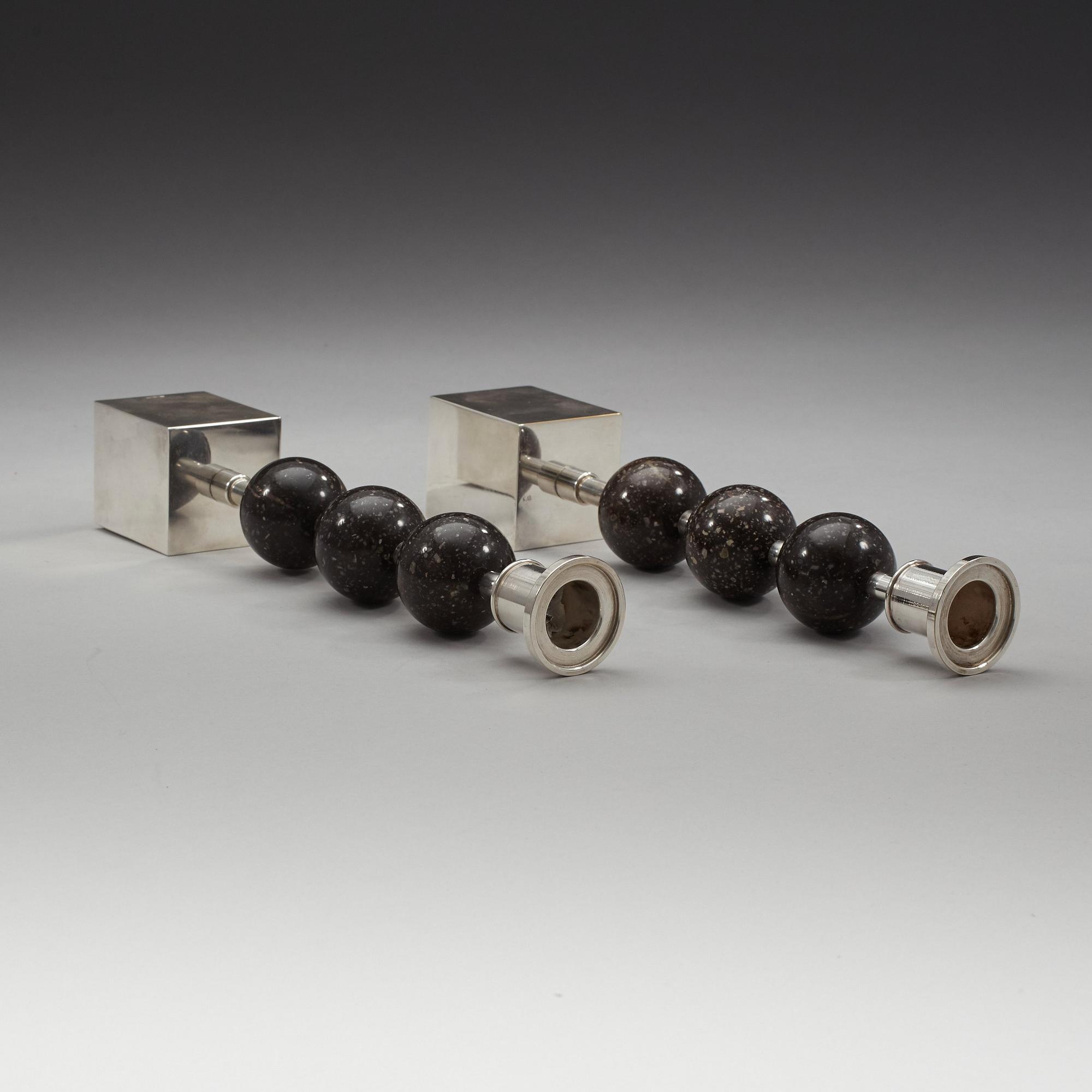 Sigurd Persson, a pair of silver plated and porphyry candlesticks, Sweden.