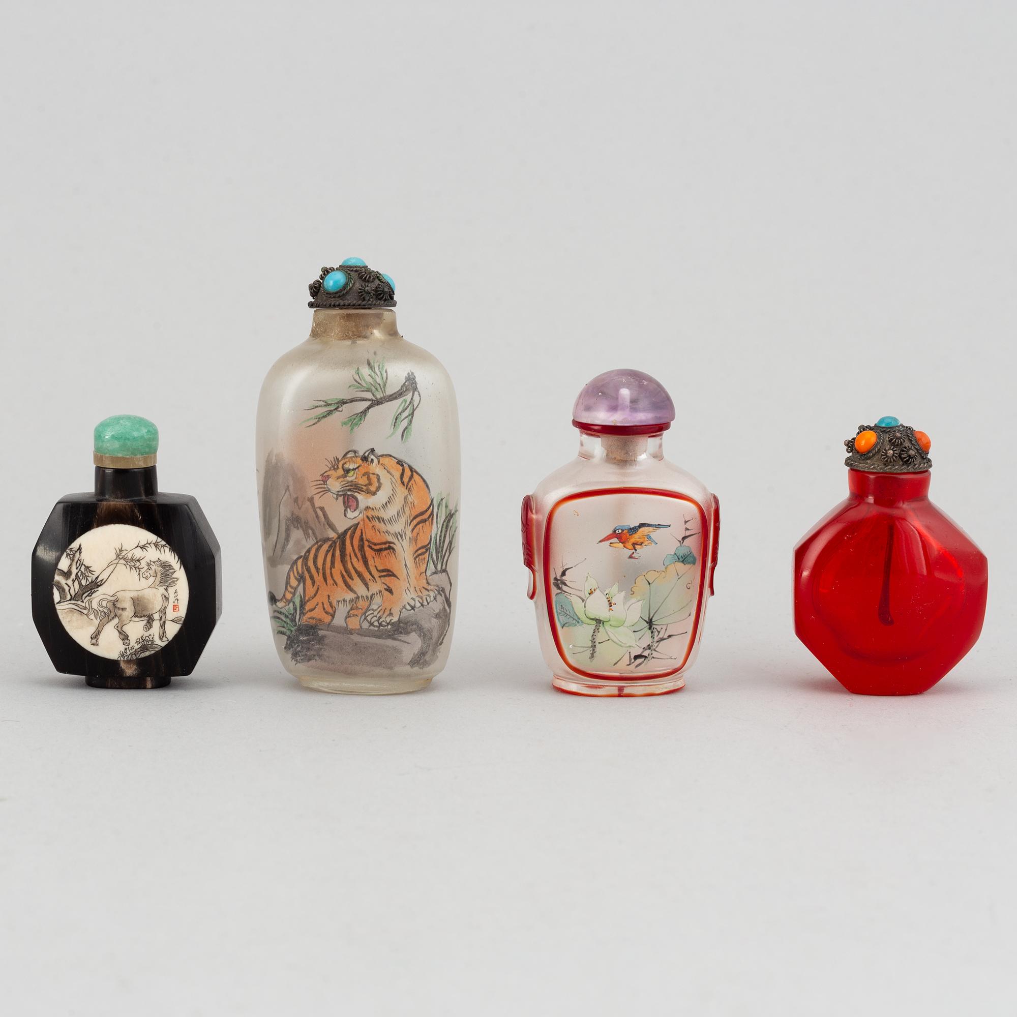 Four Chinese snuff bottles in glass and stone, 20th century.