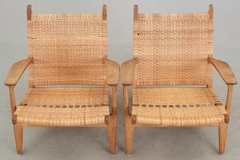 A pair of Hans J Wegner oak and rattan 'CH-27' armchairs, Carl Hansen & Son, Denmark, 1950's-60's.