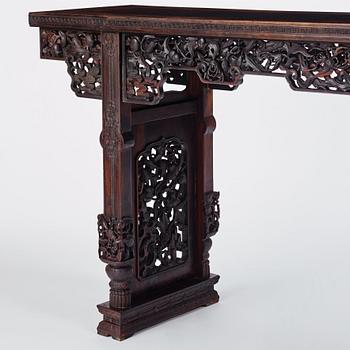 A massive zitan recessed-leg long table 'Jiaotousun Qiotouan', Qing dynasty, 19th century.