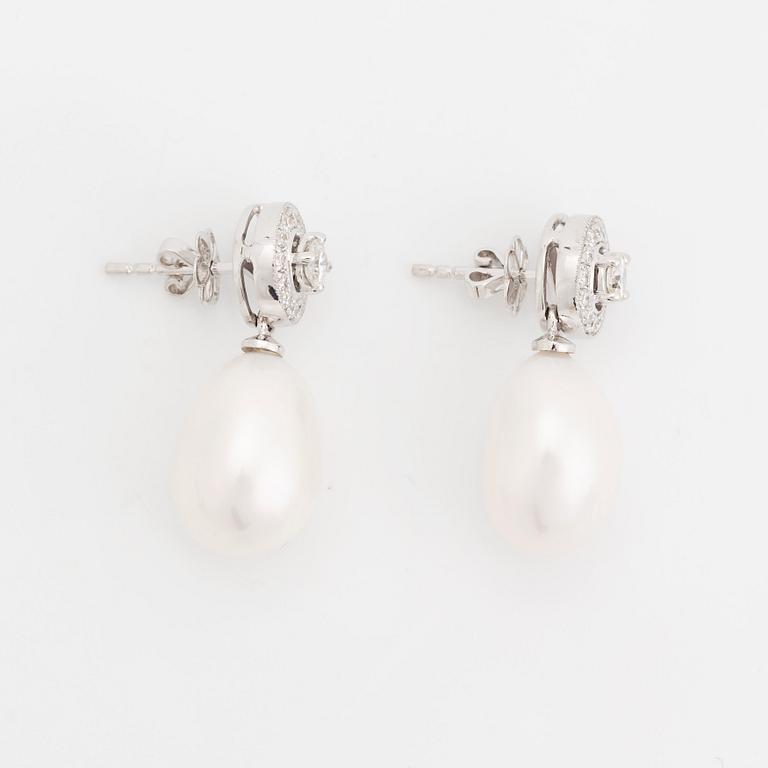 A pair of 18K white gold and cultured pearls earrings set with round brilliant-cut diamonds.