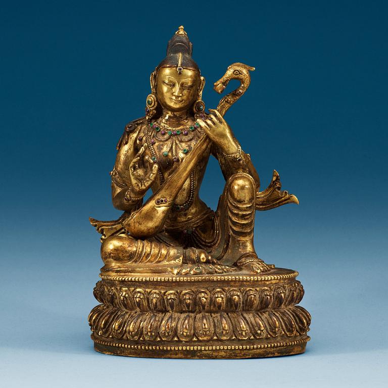 A Sinotibetan jeweled gilt bronze figure of Sarasvati, Qing dynasty, 19th Century.