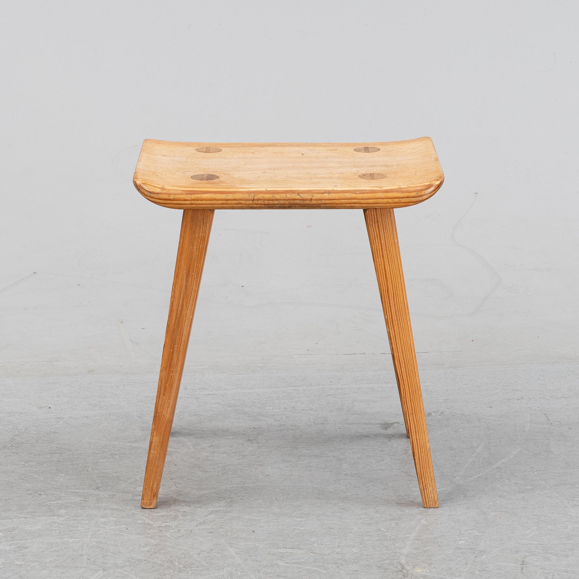 A pine stool by Carl Malmsten for Karl Andersson.