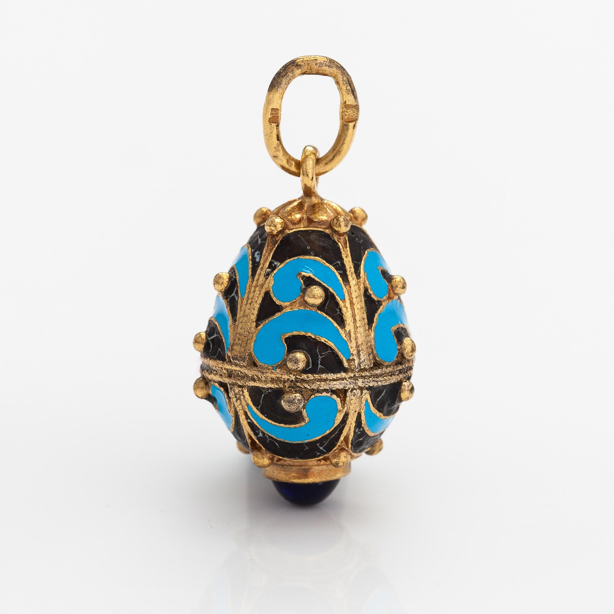 A gilded brass pendant with enamel and glass stones.