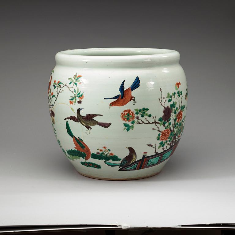 A famille rose jardiniere, decorated with a terrace scene with blossom and birds, late Qing dynasty, about 1900.
