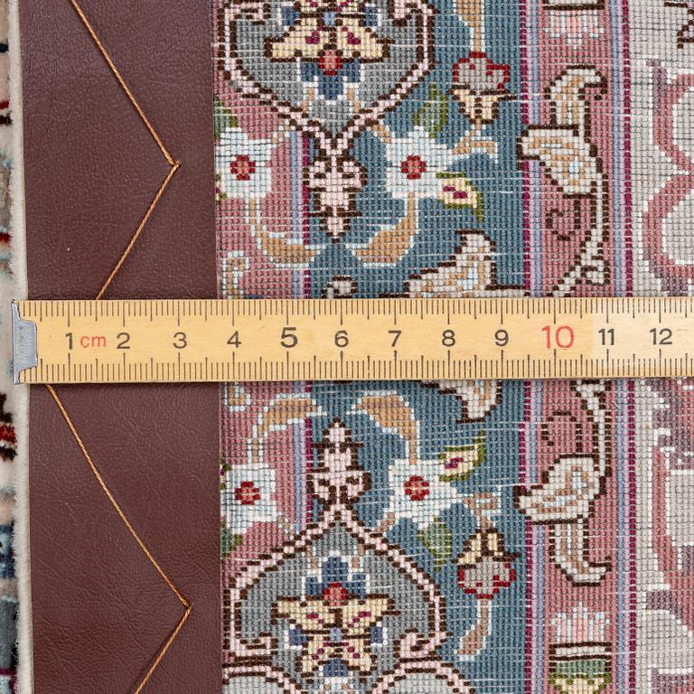 A Tabriz carpet, 210 x 195 cm. signed.