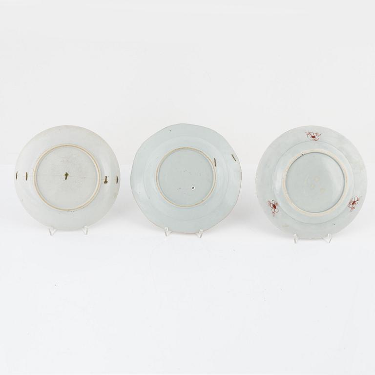 A group of seven Chinese porcelain plates and a charger, 18th / 19th Century.