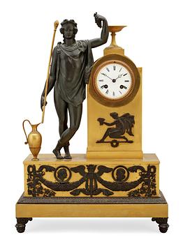 702. An Empire early 19th Century gilt and patinated bronze mantel clock.