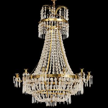 128. A Swedish gilt brass and cut glass thirteen-light Empire chandelier, early 19th century.