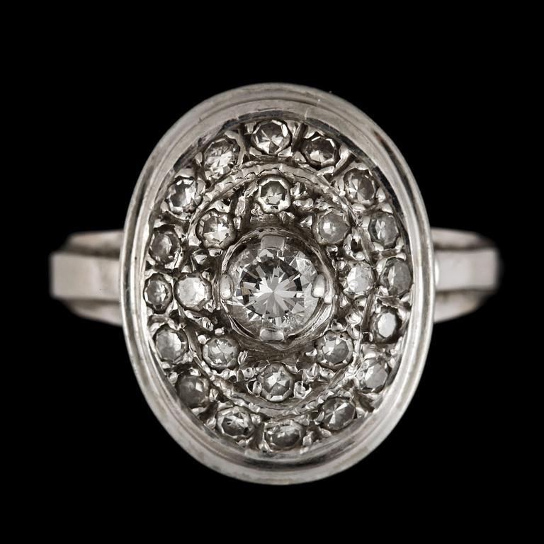 RING, 18k vitguld med diamanter mittsten ca0,22ct, mindre diamanter tot ca0,24ct. Vikt 5,8g.