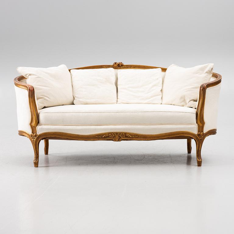 A Louis XV-style sofa, early 20th century.