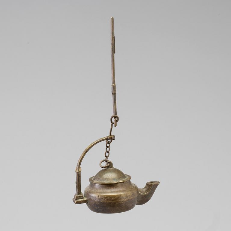 A 18th century oil lamp.