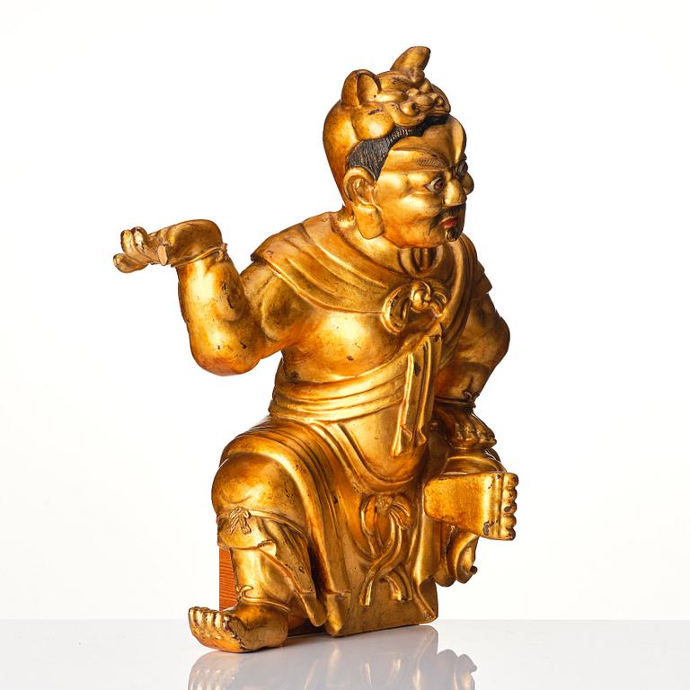 A gilt and lacquered wooden sculpture of a guardsman, Qing dynasty, 18th century.