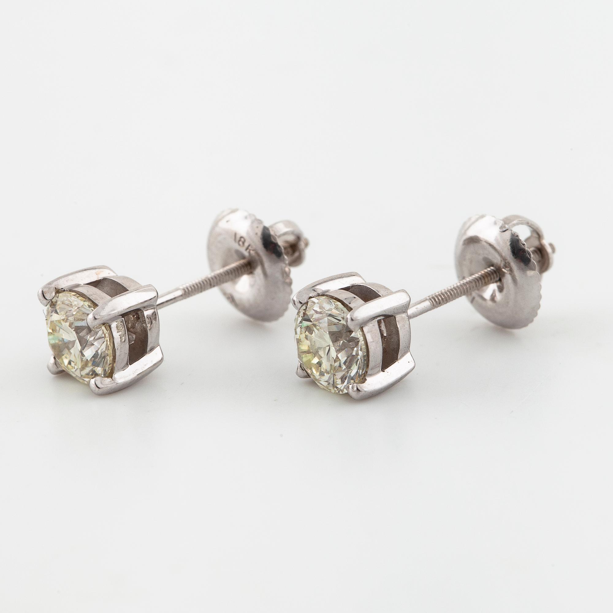 A pair of brilliant cut diamond earrings.