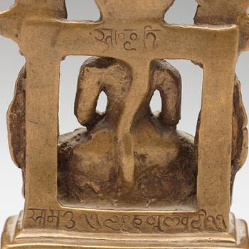 A copper alloy Jain shrine, western India, 19th Century or older. With inscription to the back.