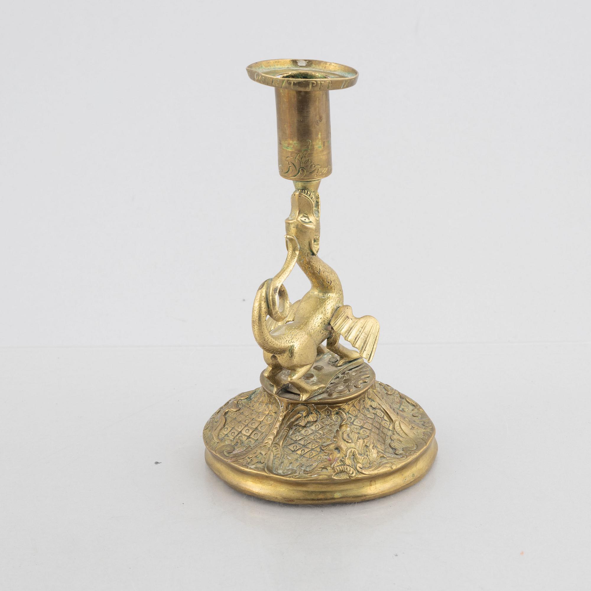 A rococo-style brass candlestick, 18th century and later.