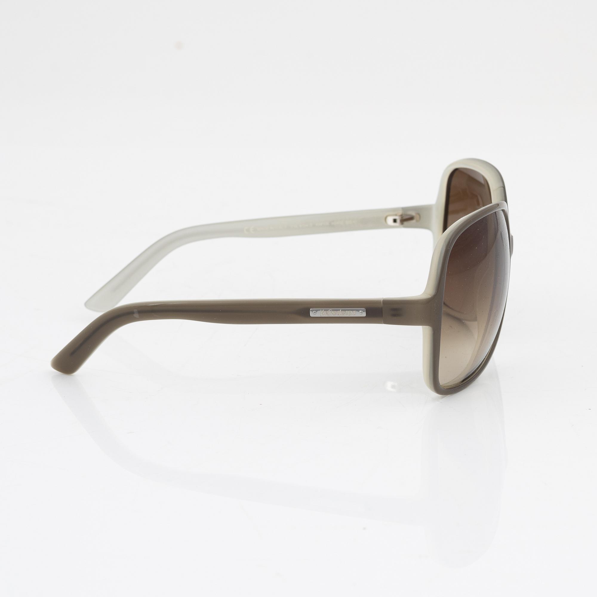 Yves Saint Laurent, a pair of grey plastic sunglasses.