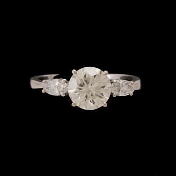 An 18K white gold ring set with one round brilliant-cut diamond and two marquise-cut diamonds.