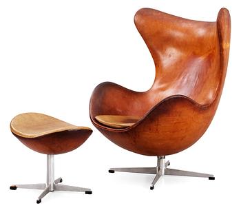 An Arne Jacobsen brown leather 'Egg chair' with ottoman, by Fritz Hansen, Denmark 1963.